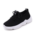 White women's thick-soled casual trainers with woven upper and front strap closure