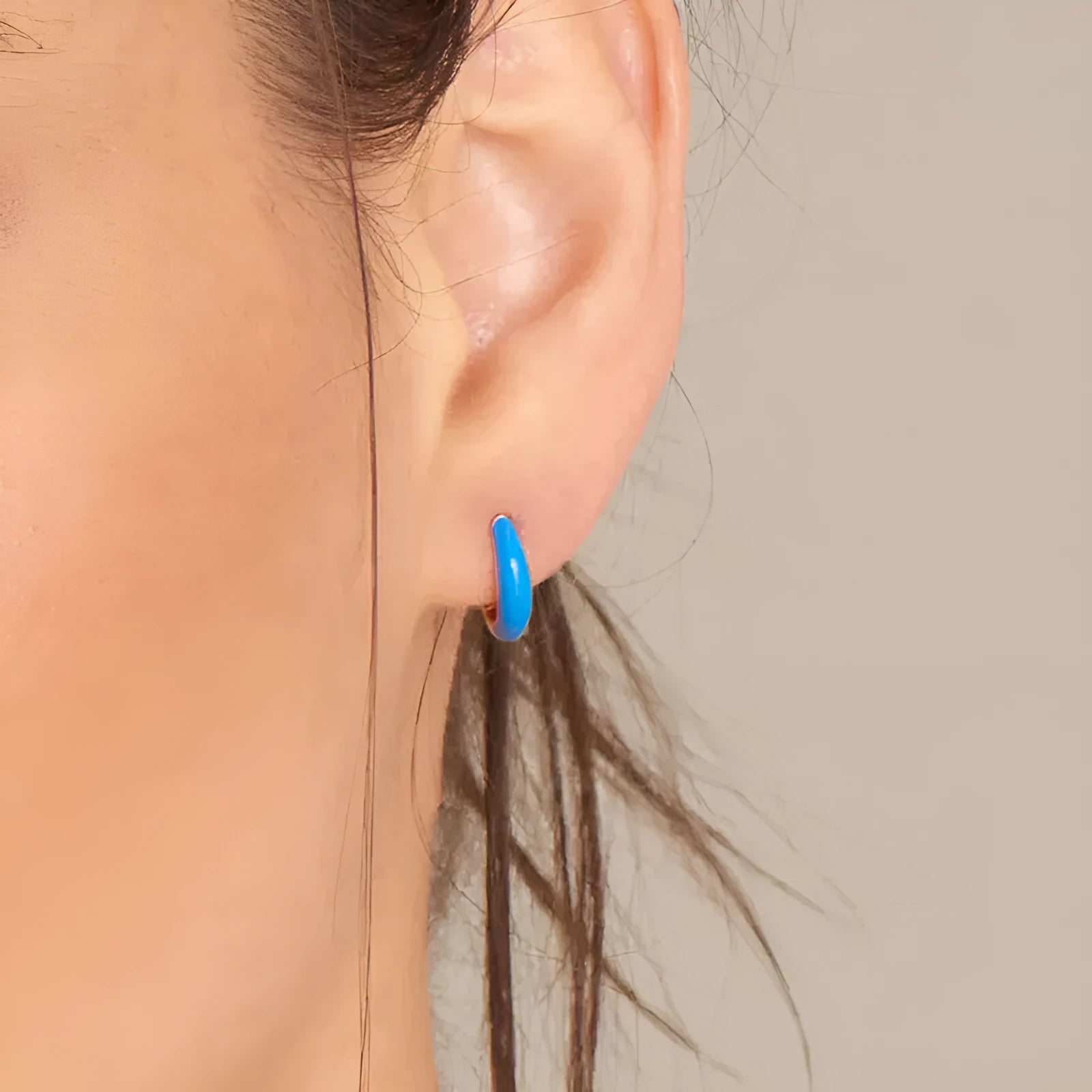 A pair of curved U-shaped oval ring stud earrings with a smooth epoxy resin finish in a selected colour.