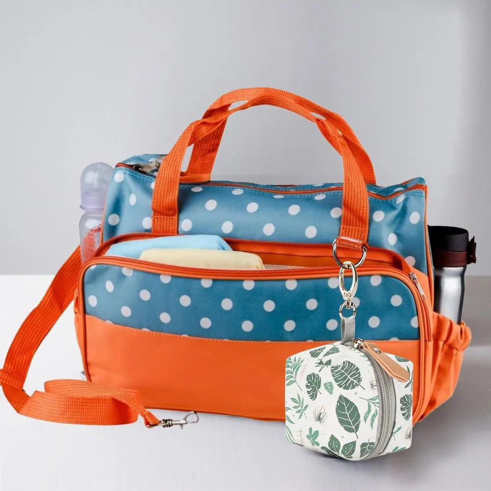 Baby pacifier holder case in PU leather with impervious nylon lining and buckle clip, holds 2 pacifiers, compact 6.35cm size
