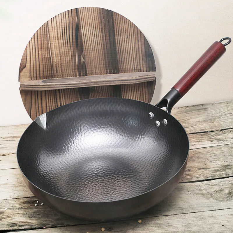 Traditional black iron wok with wooden handle showing 40cm diameter cooking surface