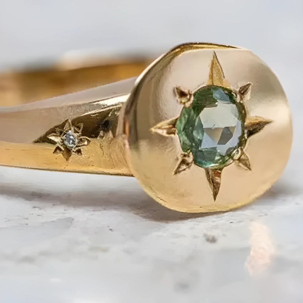 Golden star-shaped adjustable ring with a central oval asterism zircon.