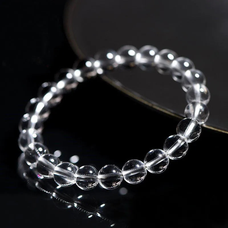 Natural Donghai old materials white crystal geometric bracelet with round beads on a wrist.