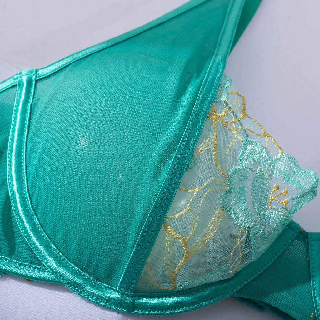 Light green women's embroidered bra set with three-point style and tights on a mannequin.