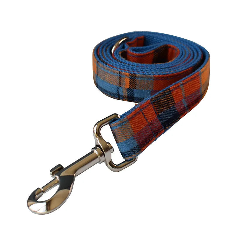 Blue background velvet plaid dog collar with a silver alloy metal buckle on a white surface.