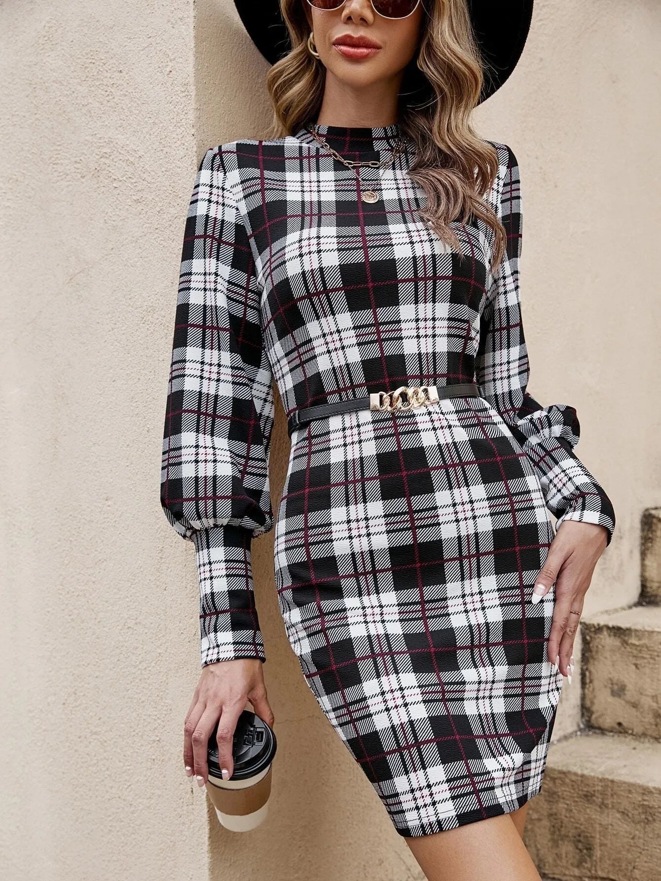 Black tight-fitting midi dress with voluminous lantern sleeves and leather stitching detail.