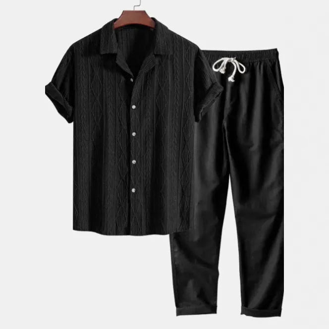 Man wearing a slim fit camouflage print short-sleeve shirt and matching trousers casual suit set.