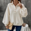 Beige women's polo collar sweater with long sleeves and a textured knit fabric.