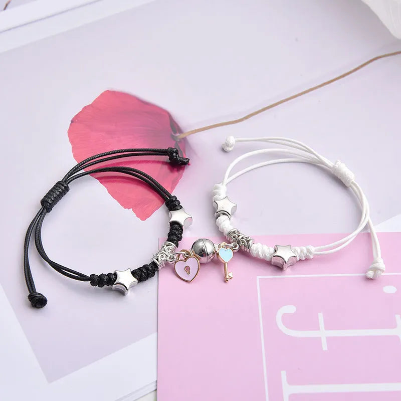 Magnetic couple's alloy bracelet pair with electroplated finish in various designs like crown, cross, and kitten.
