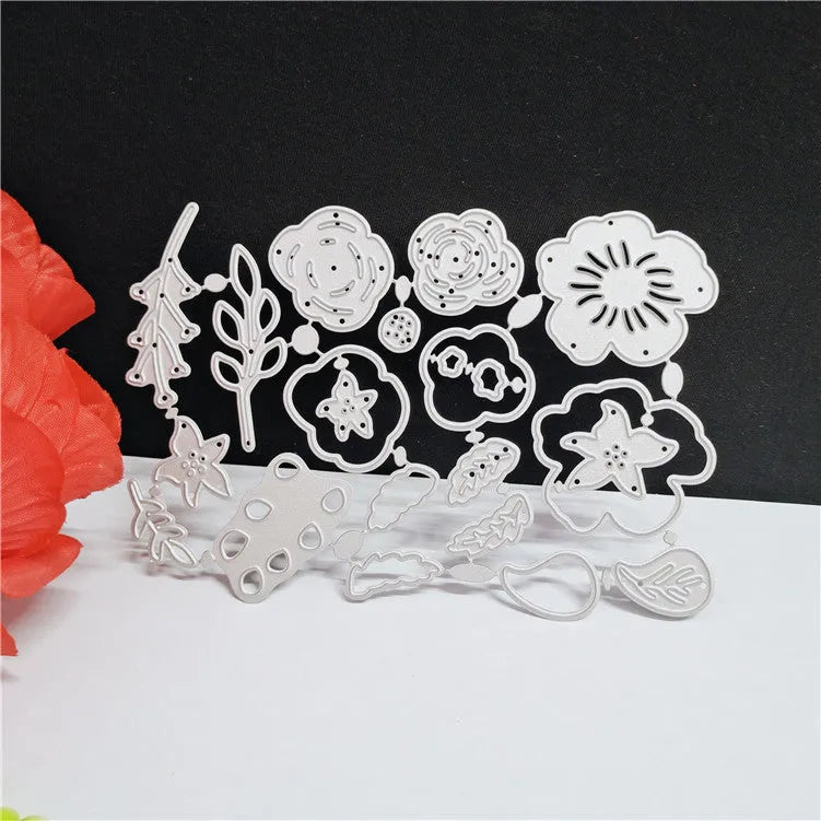 Silver carbon steel flower knife mould for paper cutting measuring 14.3cm by 9.9cm with etched botanical design