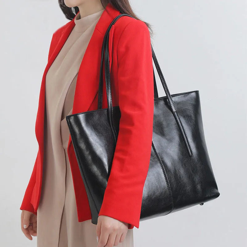 Women's retro style cowhide shoulder bag in horizontal square shape with multiple internal compartments