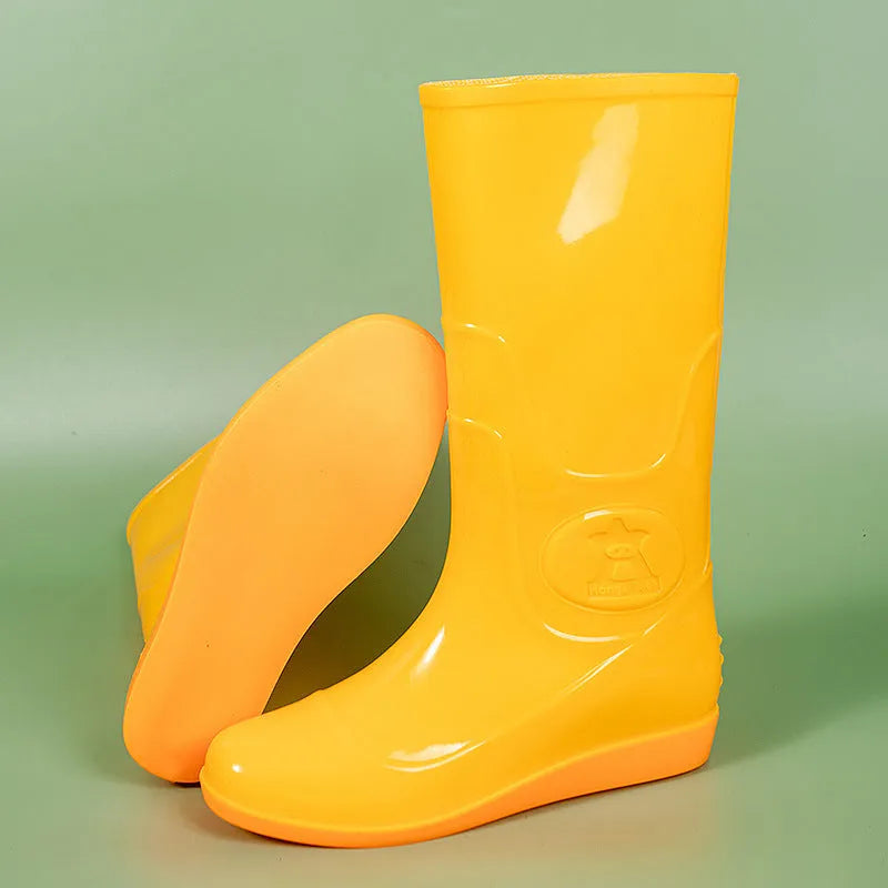 Plastic washable rain boots in white or yellow colours with high tube design and flat heel