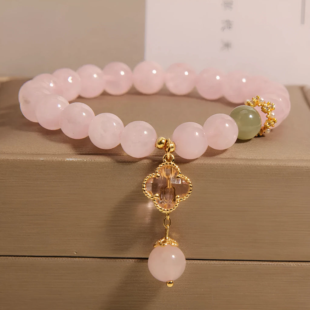 Pink crystal four-leaf clover pendant bracelet with alloy setting and rhinestone details