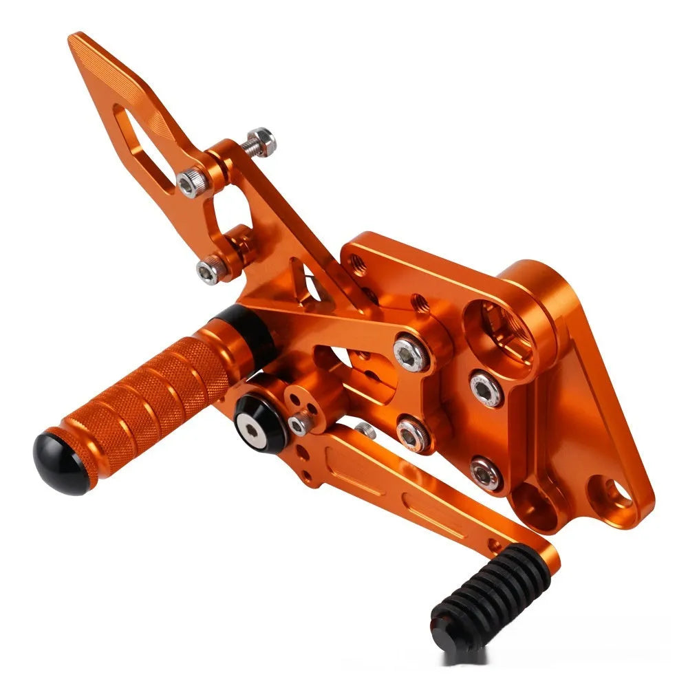 Black and orange KTM Duke motorcycle raised footrest bracket assembly
