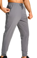 Man wearing loose-fit solid colour casual trousers in a leisure setting.