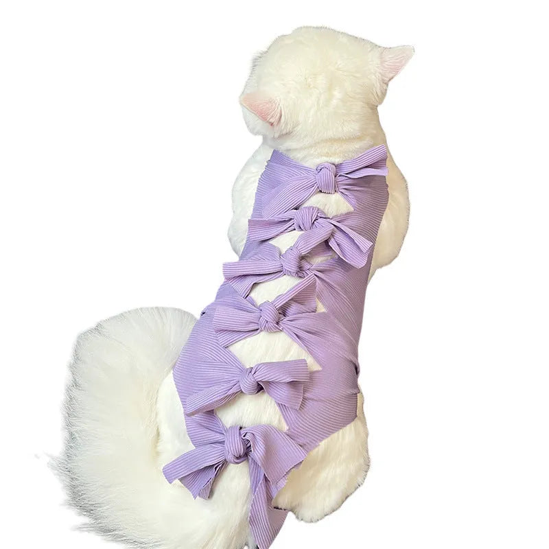 Pink lace-up cat sterilisation clothing for post-operation recovery on a small cat.