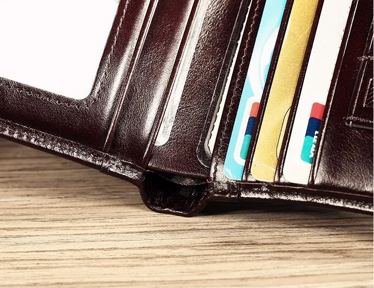 Men's black leather bifold RFID wallet open to show card slots, ID window, coin pouch, and banknote compartment.