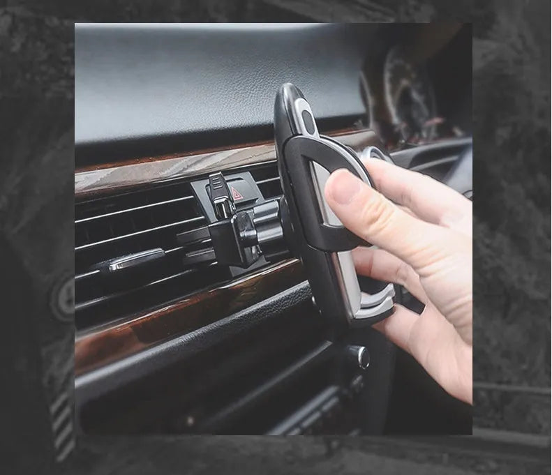 Black plastic mobile phone holder mounted on car air conditioning outlet vent