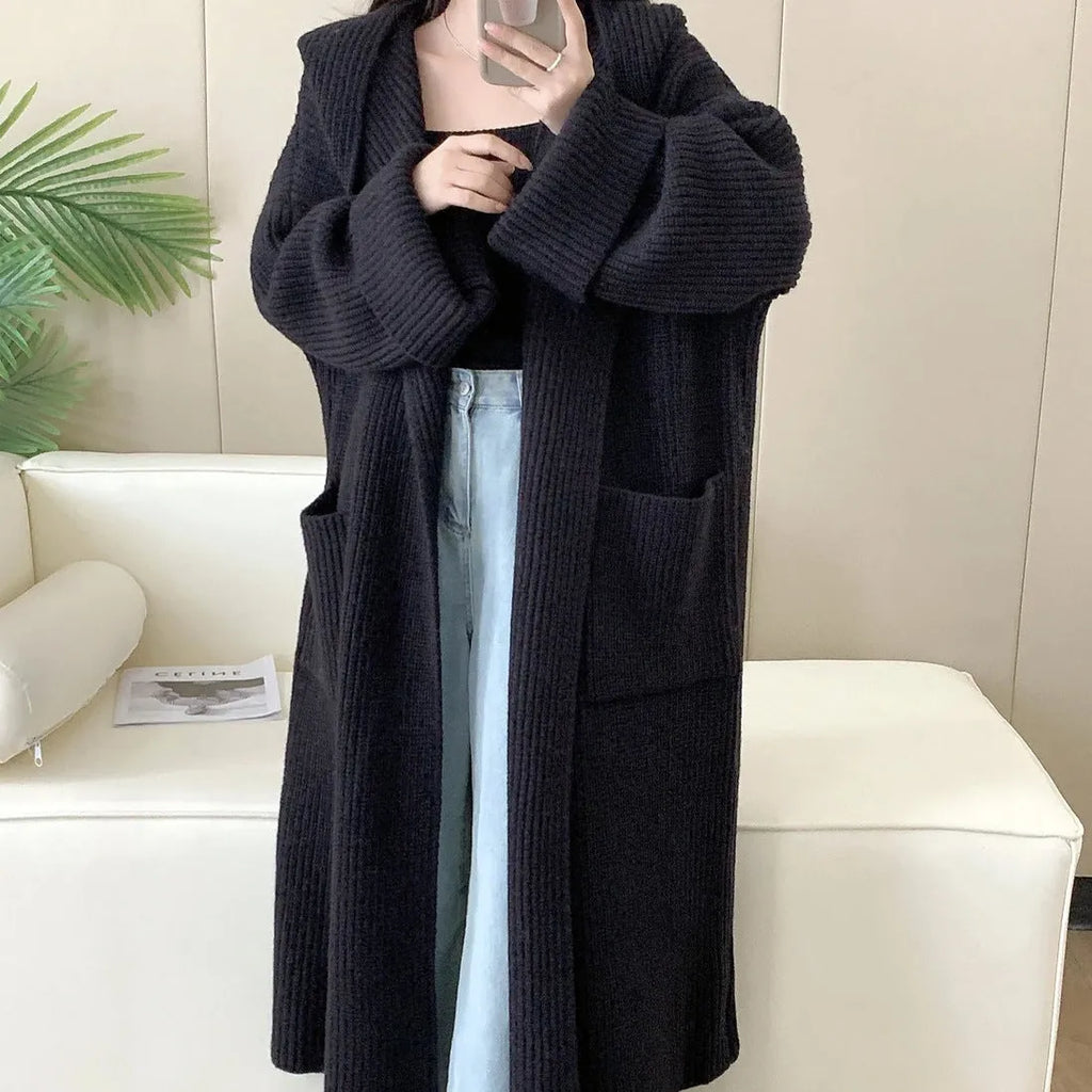 Women's loose grey hooded acrylic cardigan coat with long sleeves, shown open.