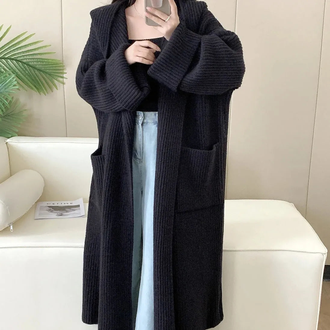 Women's loose grey hooded acrylic cardigan coat with long sleeves, shown open.