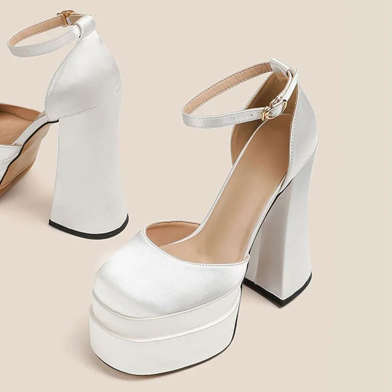 Women's white chunky heel platform pumps with a round toe and waterproof upper on a rubber sole.