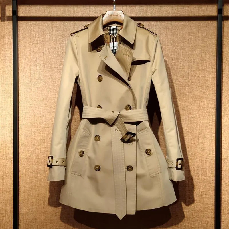 Khaki double-breasted women's trench coat with flight sleeves, shown on a hanger.