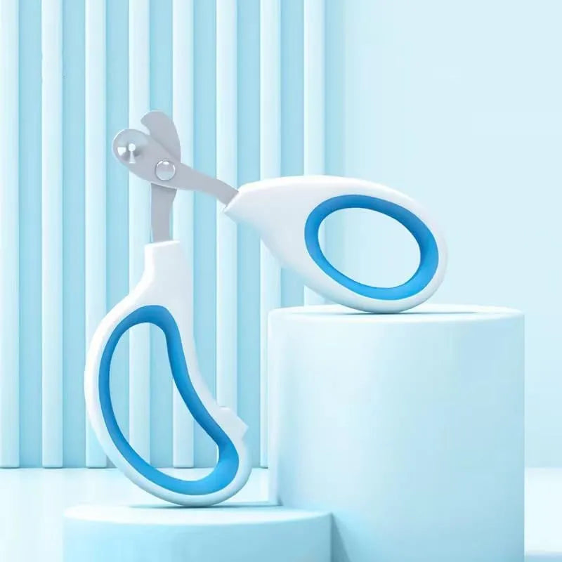 Blue cat nail clippers with a circular cutting hole and cushioned handles on a white surface.