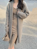Women's mid-length knitted V-neck cardigan in a loose fit, shown in khaki colour.