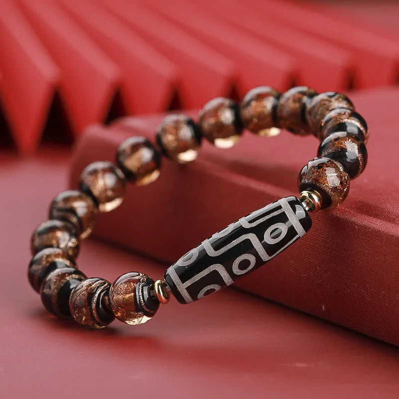 Chinese-style bracelet with coloured glaze beads showing snake and multi-treasure patterns.
