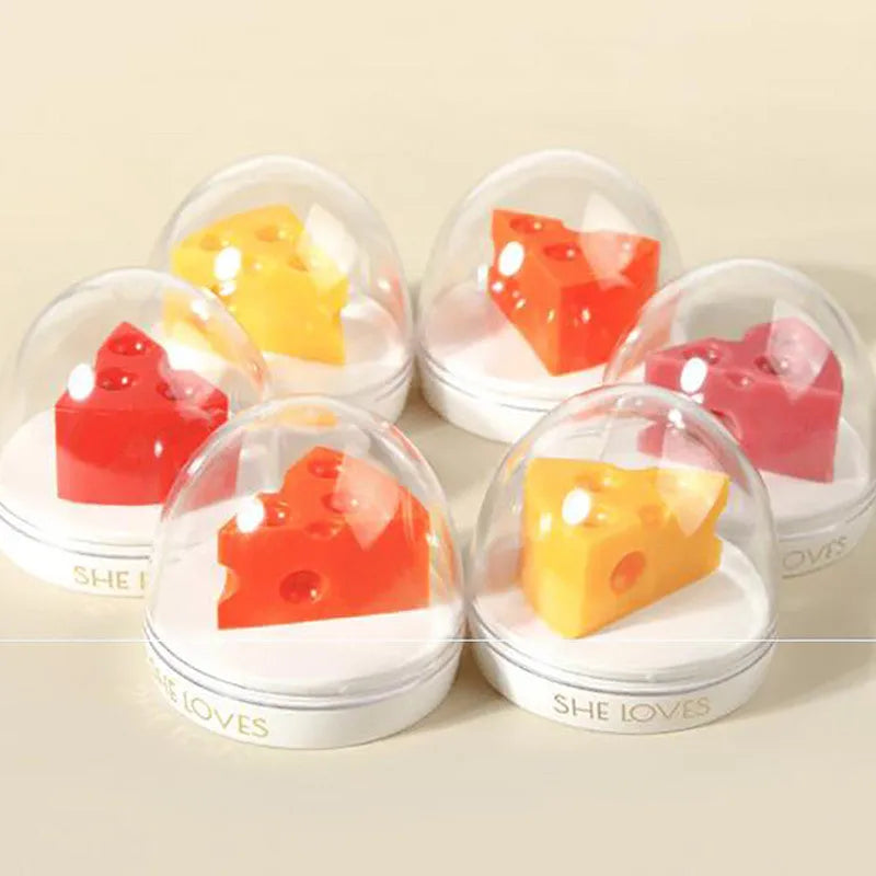 Pink cheese-shaped lip balm with Vitamin E and cream scent in open case with brush applicator