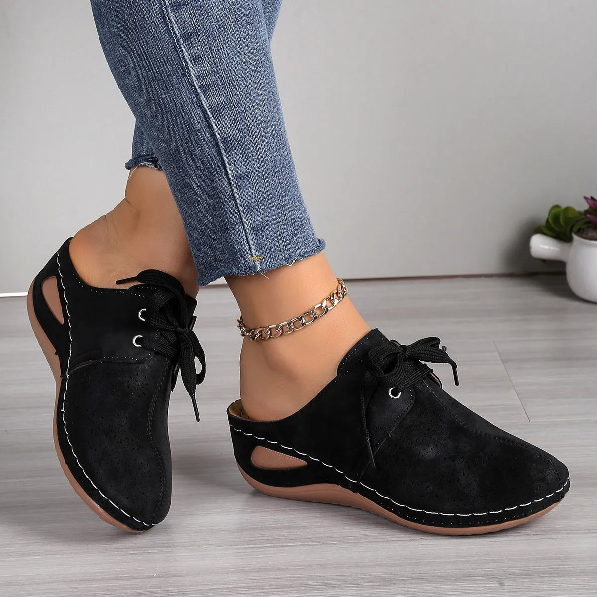Women's suede lace-up wedge sandals in light grey showing hollow-out design and rubber sole