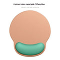 Silicone mouse mat with built-in wrist rest in a gradient colour option on a desk.
