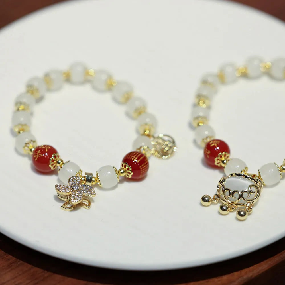 Chinese style women's glass bracelet with fu character and safety lock charms.