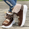 Women's mid-top lace-up snow boots in suede with a thick platform sole and plush lining.