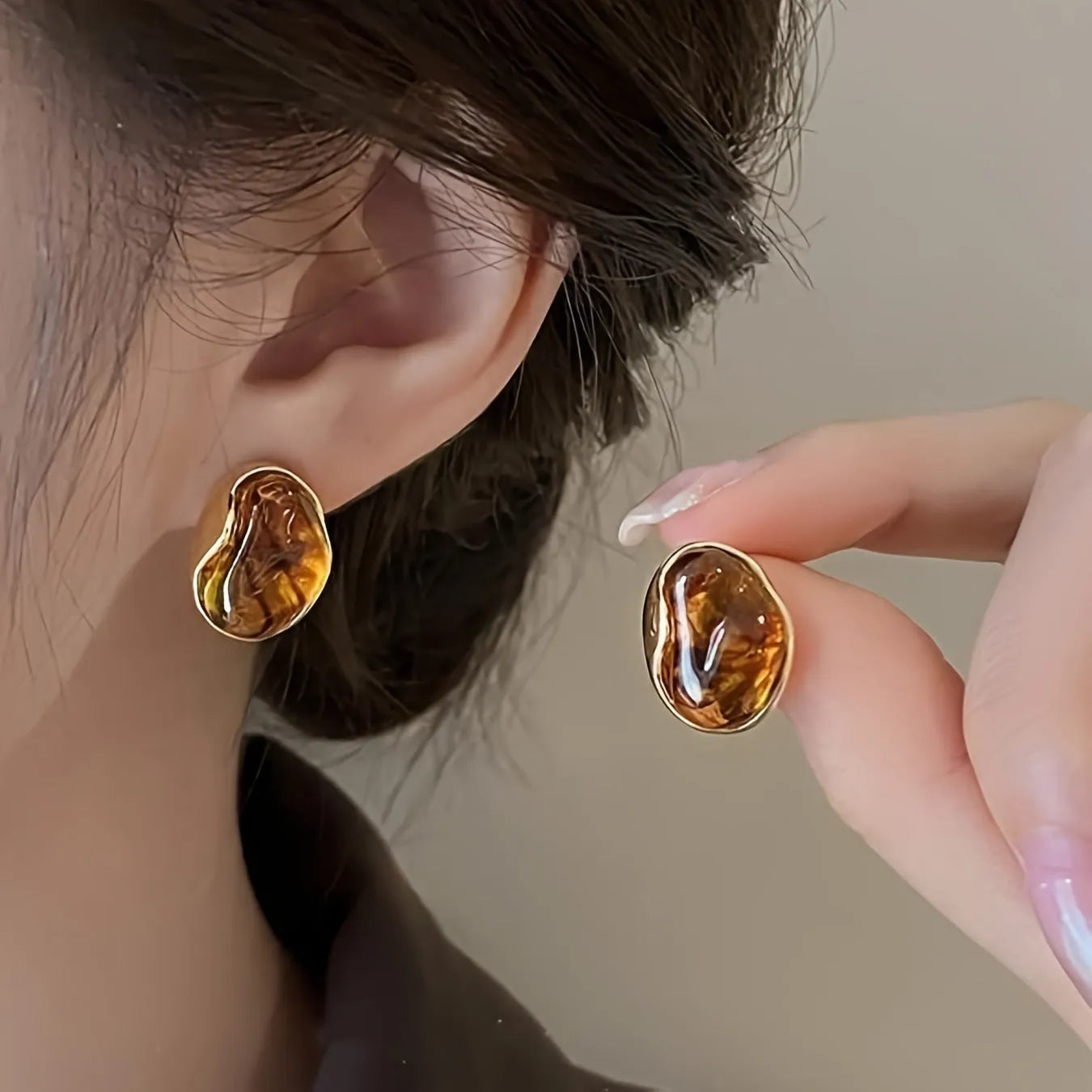 Handmade geometric alloy earrings with tassel details in three styles: round piece, irregular amber, and water drop tiger eye studs