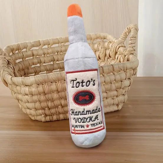 Brown wine bottle shaped plush dog toy with squeaker inside for chewing and dental cleaning
