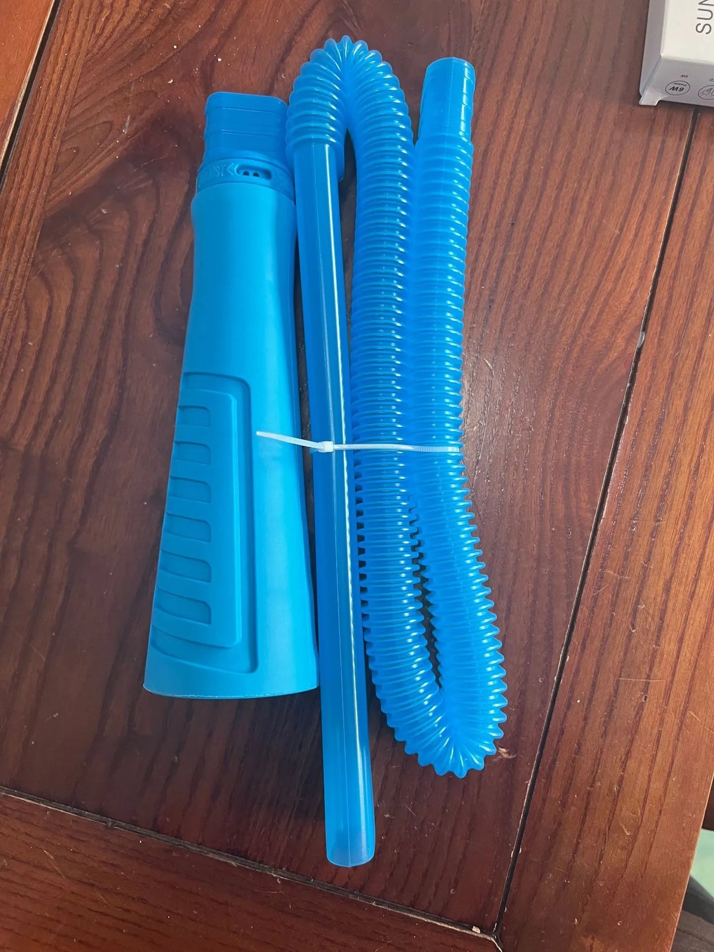 Blue plastic suction pipe cleaner with round head for washing machine dust removal