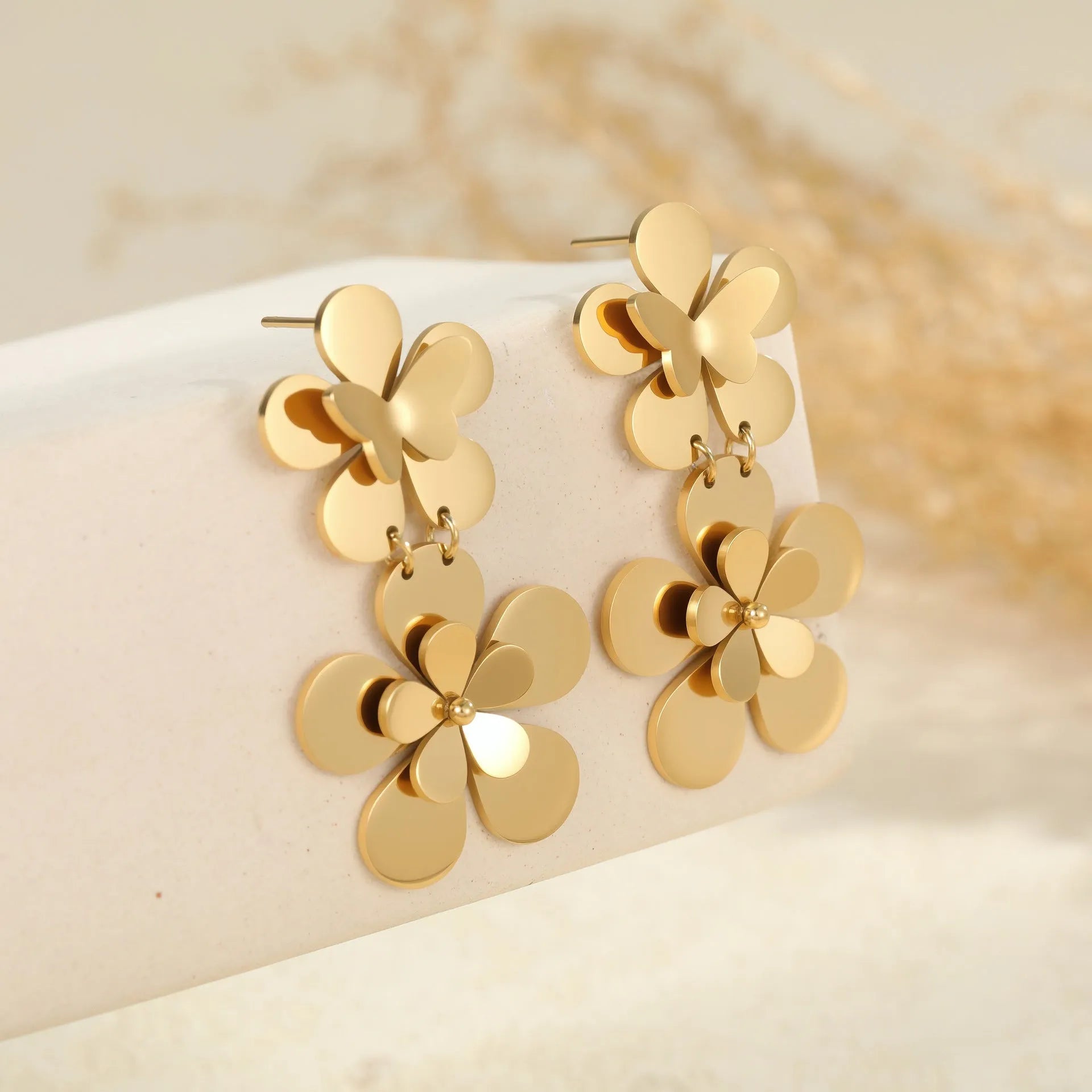 Gold flower butterfly earrings for women with geometric design on stainless steel.