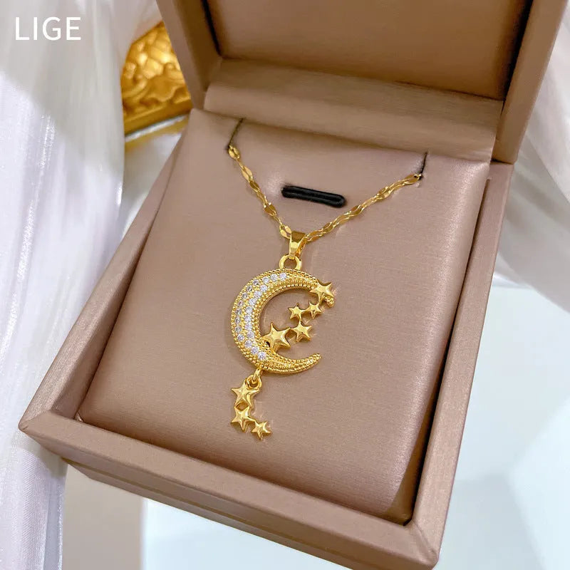Geometric moon pendant necklace with tassel on a stainless steel chain.