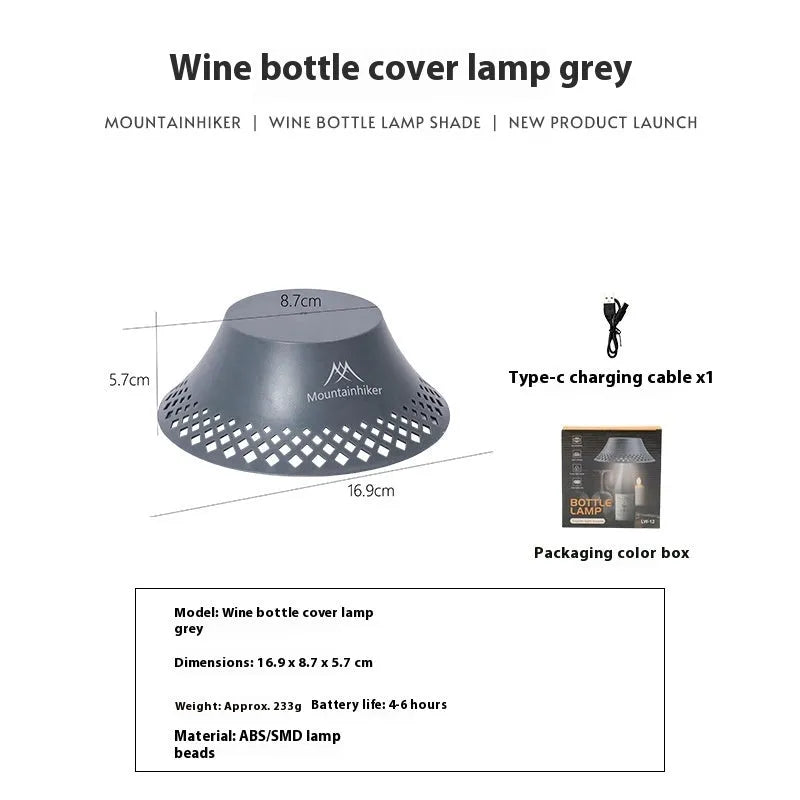 Beige and grey portable camping lantern with a wine bottle shaped lampshade and USB-C charging port.