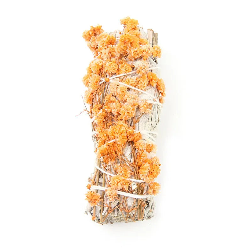 White sage and red rose petal colourful aromatherapy incense bundle on a wooden table