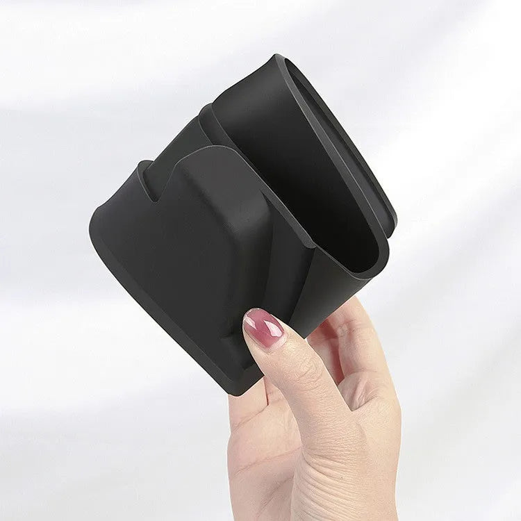 Black silicone sunglasses case mounted in a Tesla Model 3 or Y centre console.