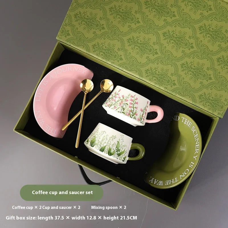 Ceramic coffee cup and saucer set for two with stirring spoons in two design choices.
