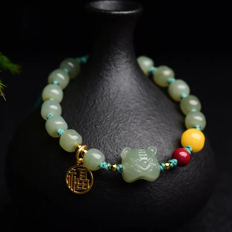 Natural Hetian Jade bracelet with cinnabar and beeswax beads, showing Zodiac modelling on 5x7mm beads.