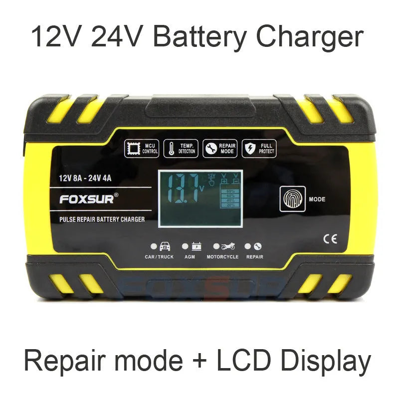 12V 24V vehicle battery charger with digital display and UK plug on a workbench.