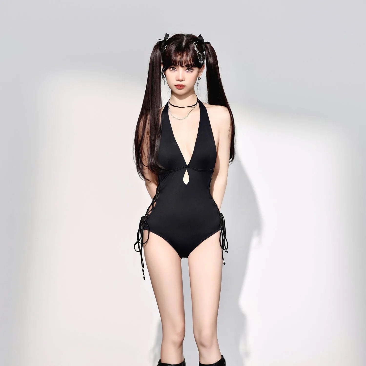 Black women's V-neck one-piece swimsuit with hollow strap design