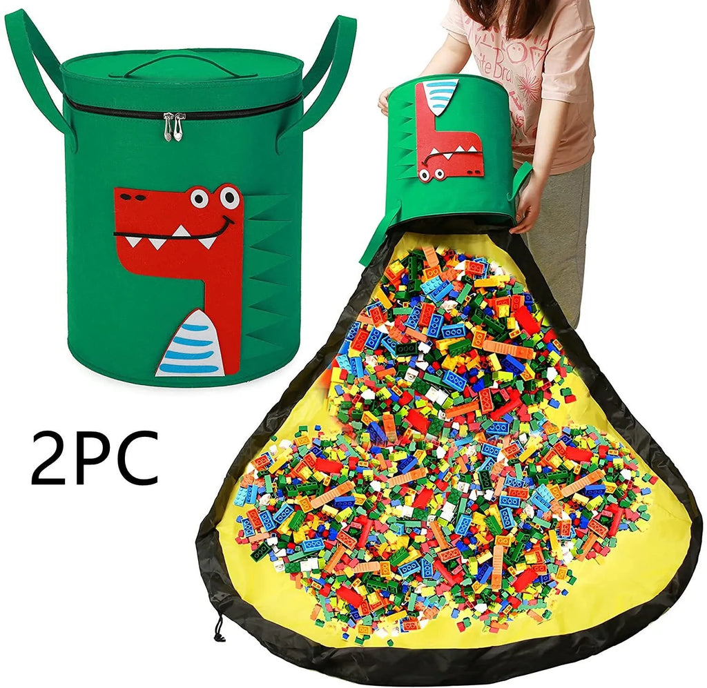 Green felt cube-shaped toy storage bag opened flat as a play mat next to toys, showing pull rope.