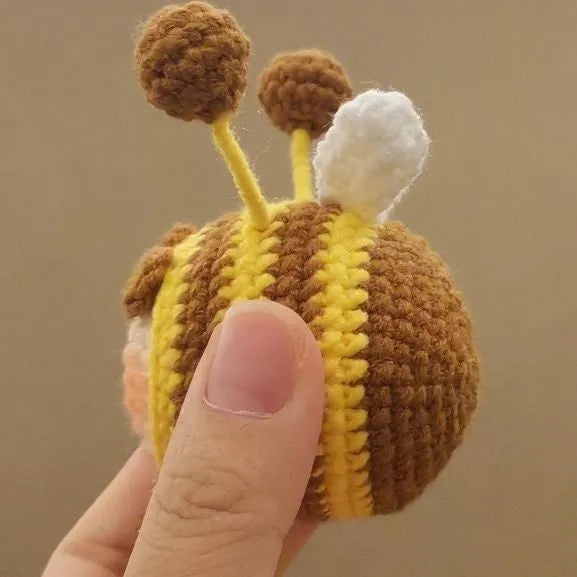 Handmade crocheted bee colony pendant accessory for a woolen doll.