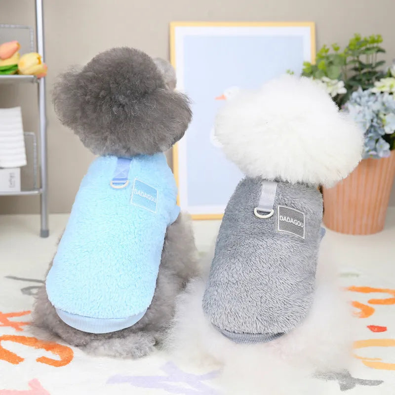 A blue coral fleece pet jacket for dogs or cats with a pull-ring fastening, laid flat.
