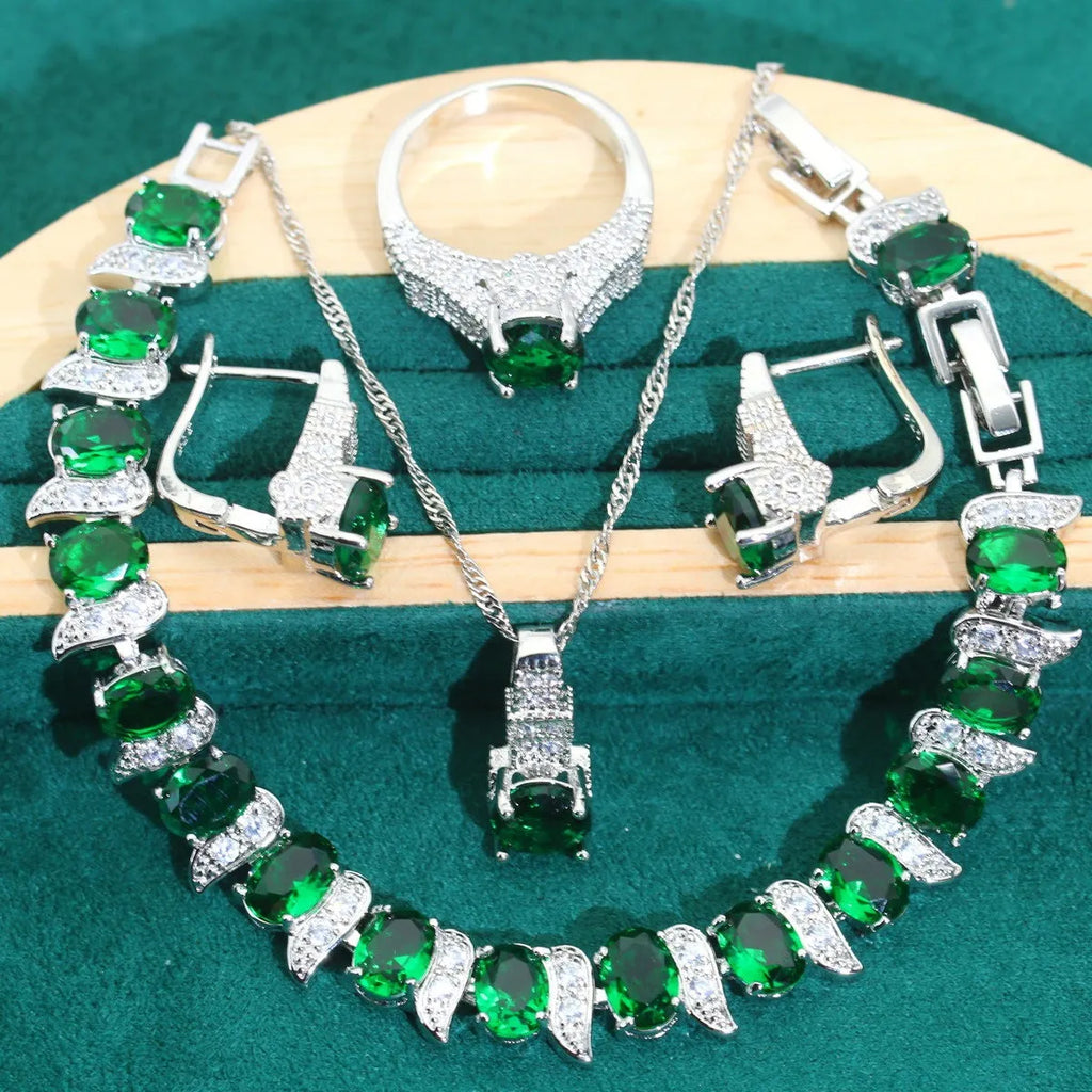 Four-piece bridal zircon jewellery set showing necklace with water wave chain, bracelet, earrings, and ring in alloy with coloured zircon stones