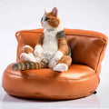 Lazy cat and sofa miniature car dashboard ornament made from resin, approximately 7.5cm high.